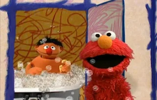 Elmo opens the door and encounters Ernie taking a bath in a tub. Sesame Street Elmo's World Bath Time