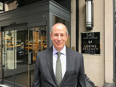 Peter Slatin standing outside the Loews Regency Hotel at 540 Park Avenue in New York City