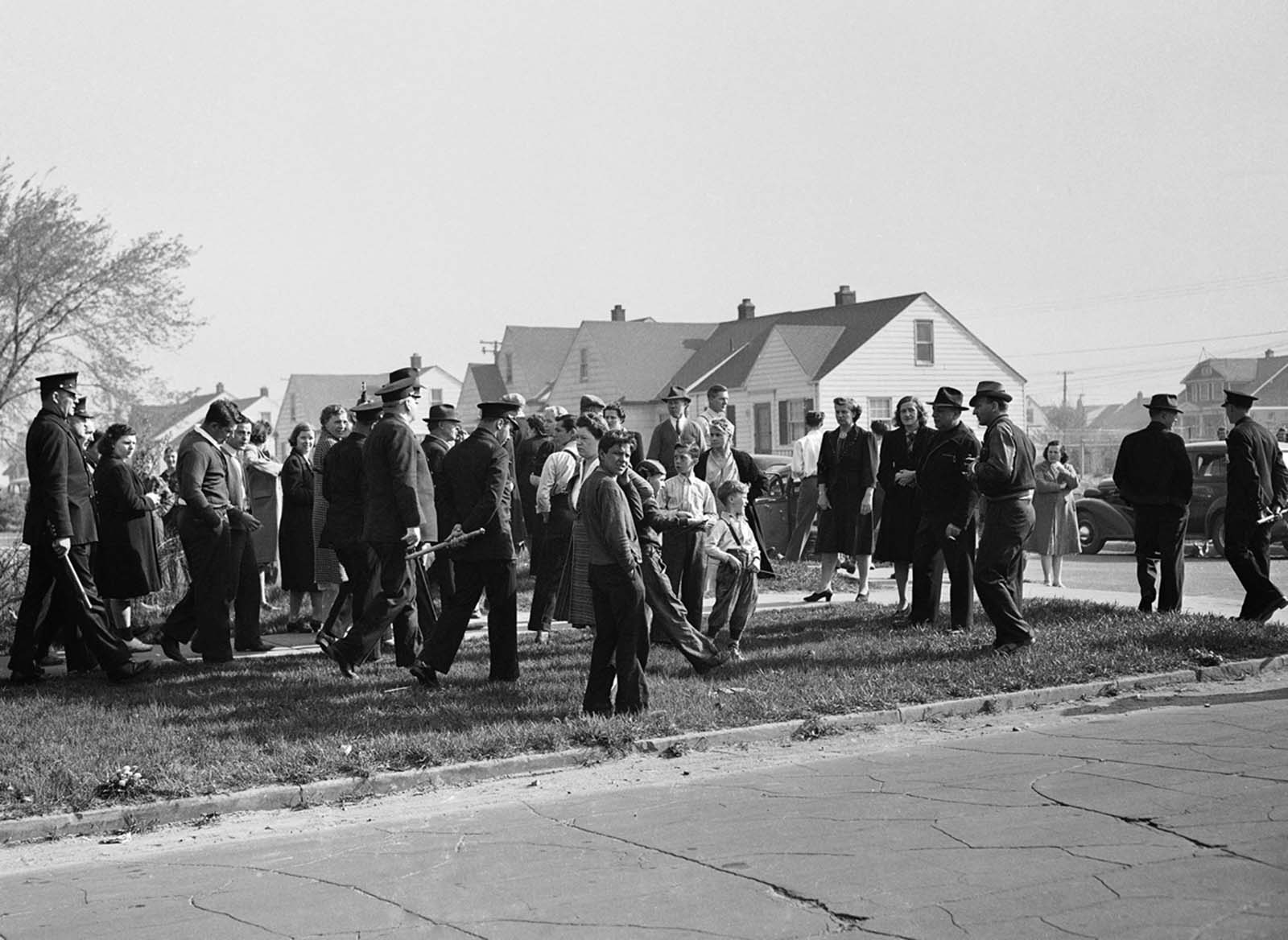 Detroit police disperse white picketers who objected to occupancy by blacks of Sojourner Truth Federal housing project, erected in a predominately white neighborhood, on April 29. 1942.