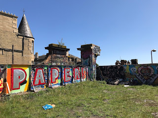 Graffiti on wall running up to site of bridge - the word Paper with an exclamation mark is spray painted in red and silver.  A building standing on Leith Walk can be seen in the left hand corner of the photo.  Photo by Kevin Nosferatu for the Skulferatu Project