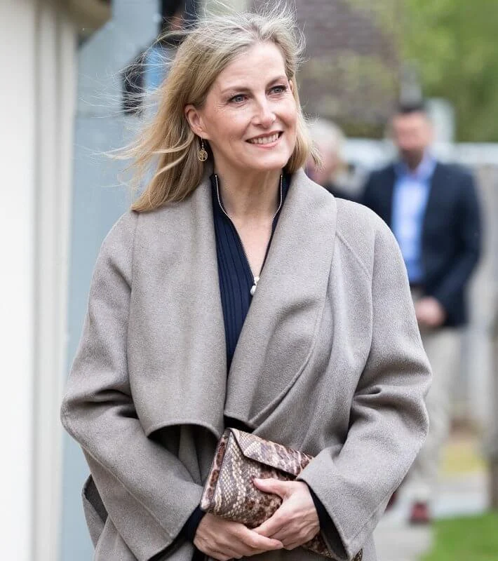 The Countess of Wessex wore a new pearl zip navy knitted pleat dress from ME+EM. Sophie Habsburg money penny clutch