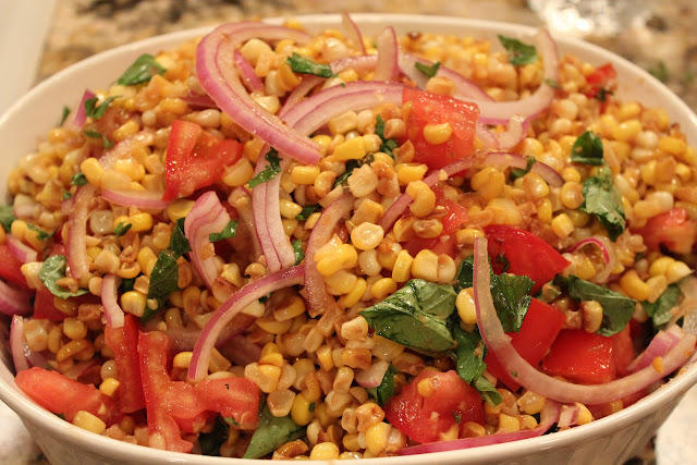 Corn salad with basil, tomatoes, and red onion