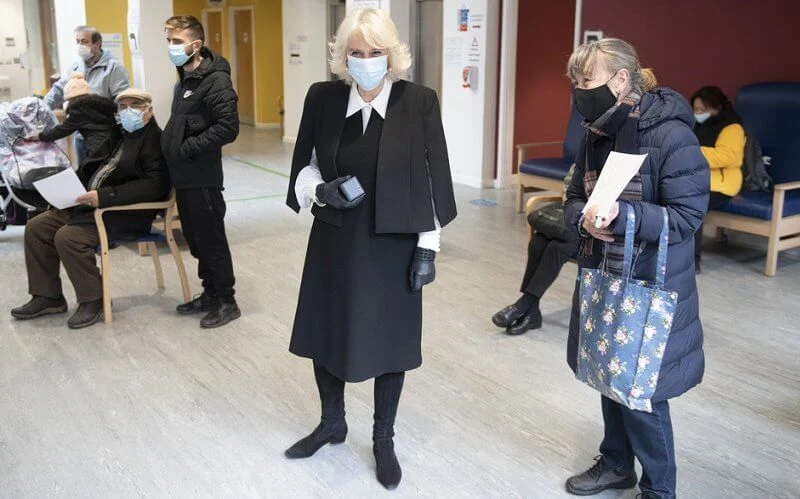 The Duchess wore a black cape and pearl earrings