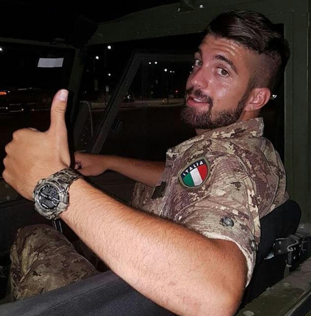 handsome-bearded-young-male-italian-soldier-military-uniform-thumbs-up-car