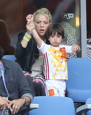 1a Shakira and sons cheers on her husband football star Gerard Pique during his game.