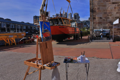 Plein air oil painting of Port Authority workboat 'Millers Point' being lifted by crane next to Moore's Wharf painted by marine Artist Jane Bennett