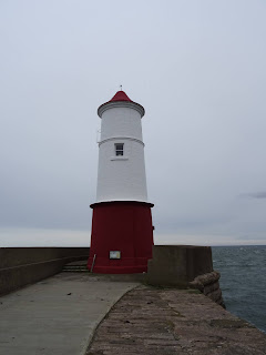 Berwick Lighthouse, a red and white lighthouse on the end of a pier in Berwick upon Tweed.  Photo by Kevin Nosferatu for the Skulferatu Project.Photo by Kevin Nosferatu for the Skulferatu Project.