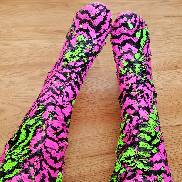 wearing thigh high boots with flip sequins in green and pink zebra pattern