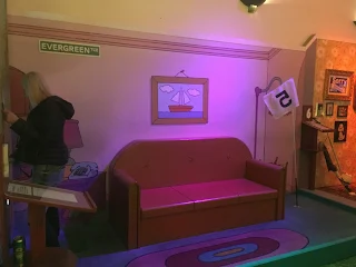 A replica of the Simpson's living room with couch at Holey Moley mini golf