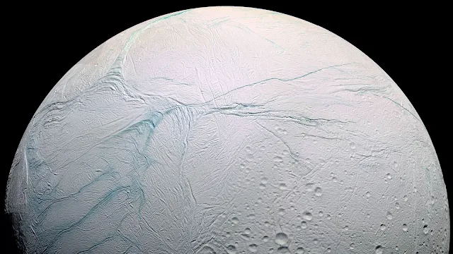 Long lines called tiger stripes are known by scientists to be spewing ice from the surface of Saturn’s moon Enceladus, creating a cloud of fine ice particles over the moon’s south pole. This photo from the Cassini spacecraft shows those tiger stripes — dubbed here in a false-color blue.