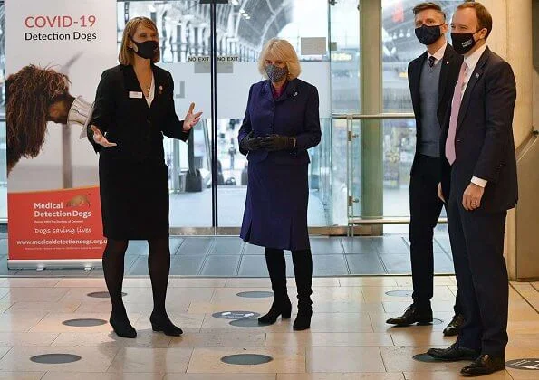 Duchess of Cornwall visited Paddington Station to watch a demonstration by the charity Medical Detection Dogs. blue navy blazer