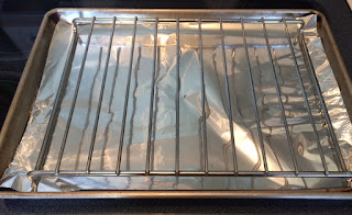 baking sheet lined with foil and baking rack on top. 