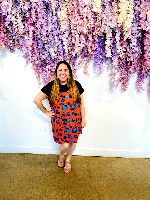 Jamie Allison Sanders enjoying the afternoon tea service and the flower wall at Morning Lavender in Orange County.