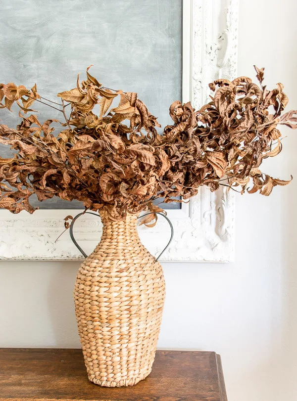 dried leaves in a basket vase