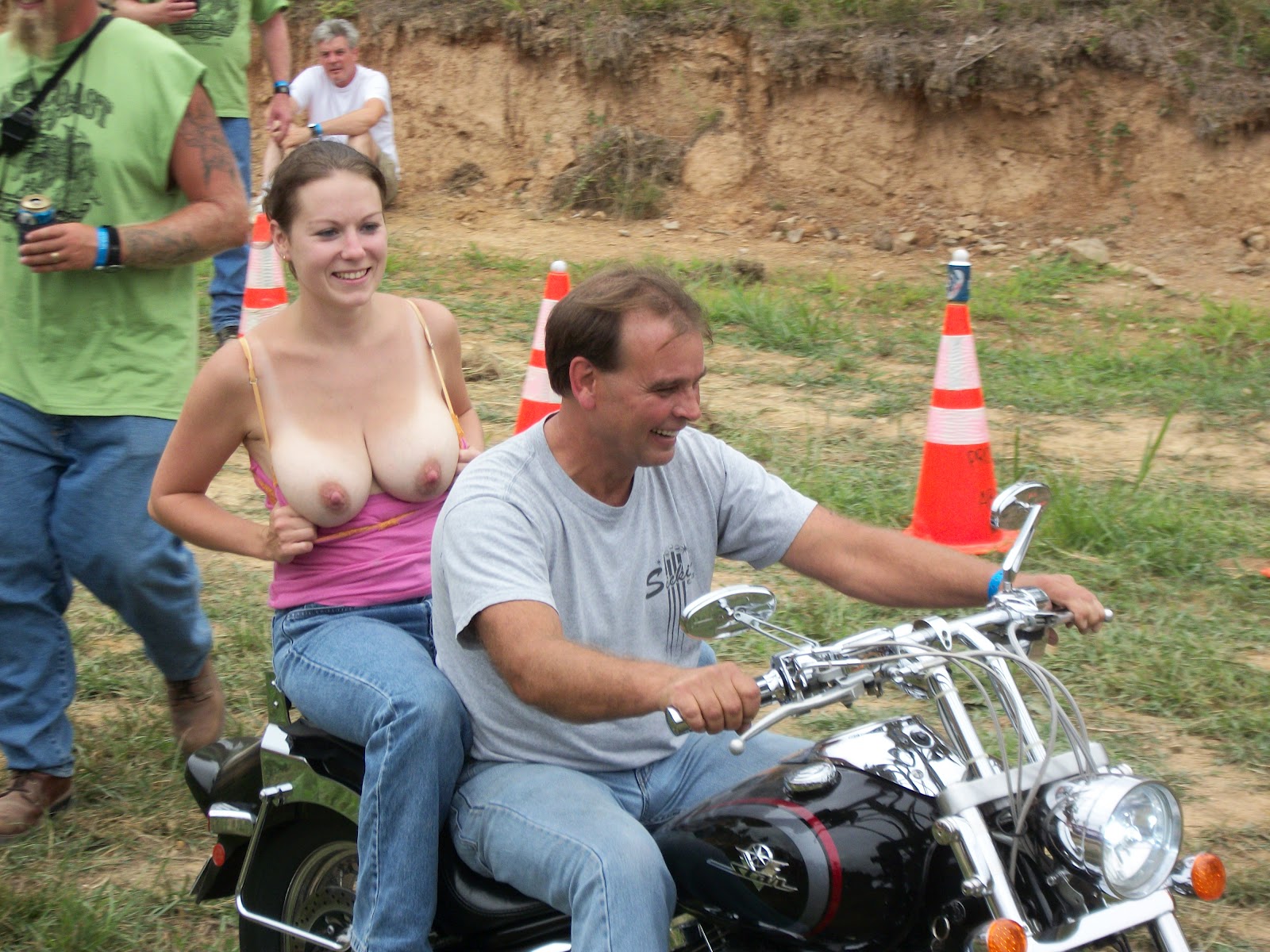 Extremely busty young topless biker chicks.