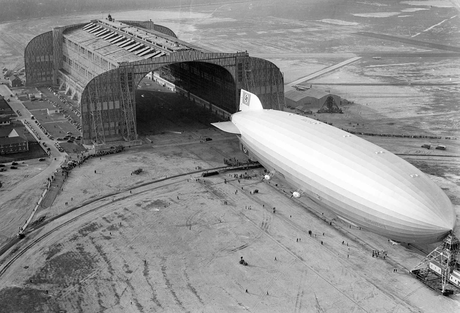 The Hindenburg trundles into the U.S. Navy hangar, its nose hooked to the mobile mooring tower, at Lakehurst, New Jersey, on May 9, 1936. The rigid airship had just set a record for its first north Atlantic crossing, the first leg of ten scheduled round trips between Germany and America. 