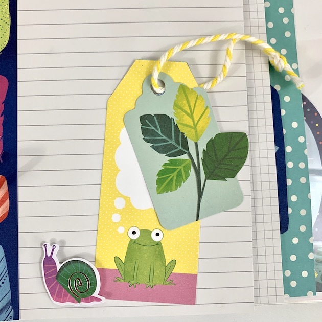 Never Grow Up scrapbook album page with a frog, snail, and scrapbooking tags