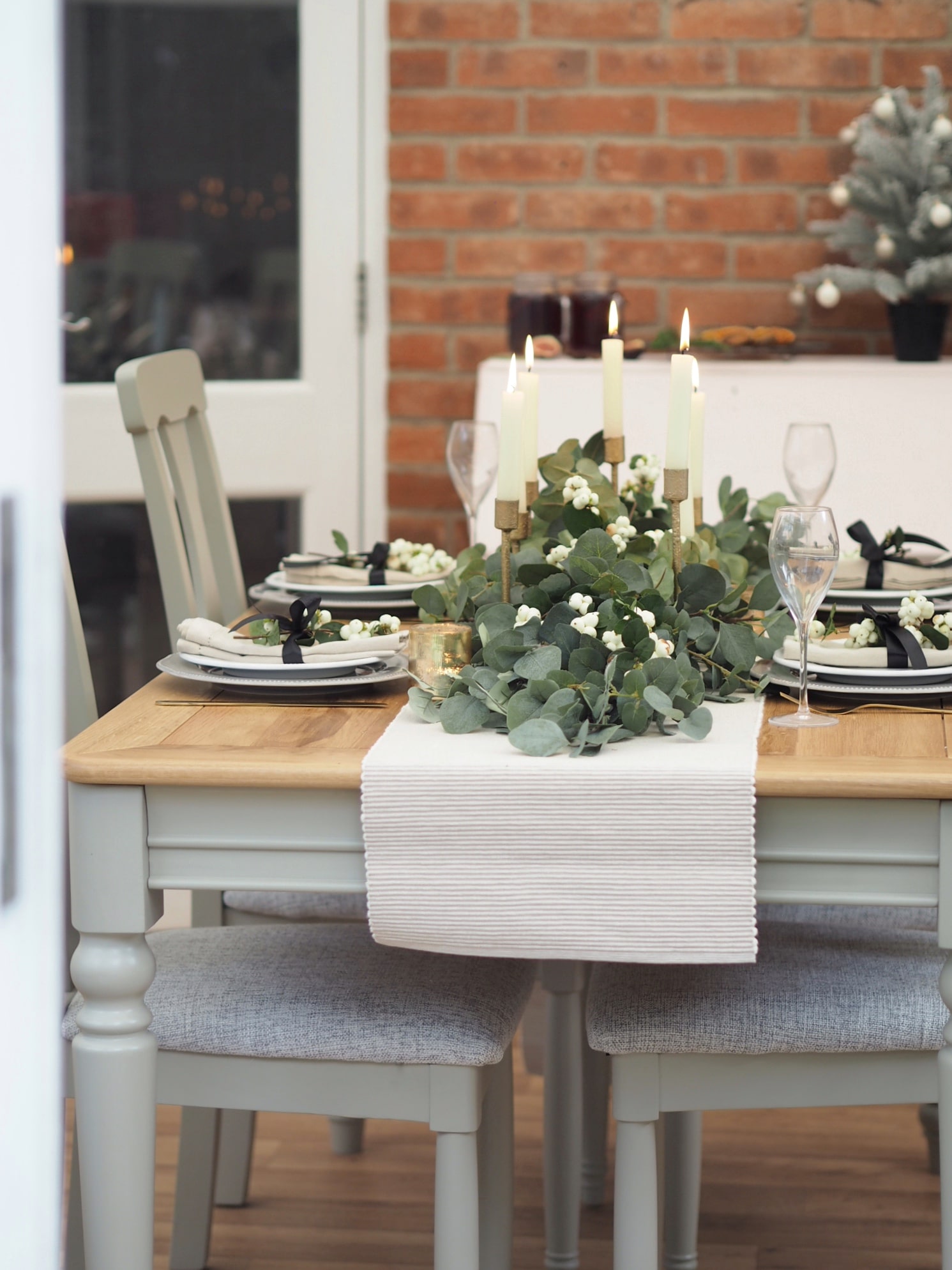 Christmas dining table decor, how to create a garland from faux eucalyptus stems to DIY a budget show-stopping display at home for your Christmas meal