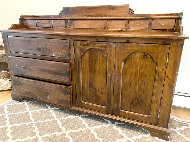 Before photo of old brown sideboard.