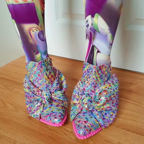 wearing galactic tights with silver pointed booties with large bow