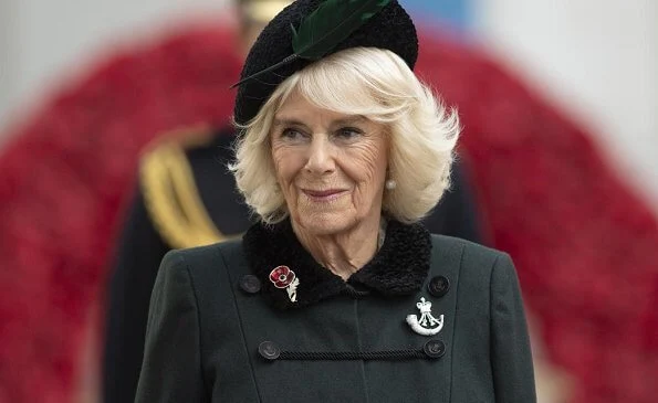 The Duchess of Cornwall wore a green wool coat at Westminster Abbey. The Duchess in a recycled green coat, and a poppy facemask