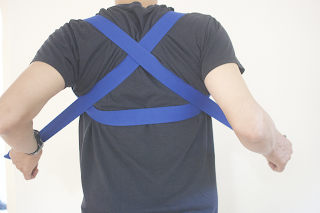 3. Cross each end of the strap with the opposite arm.
