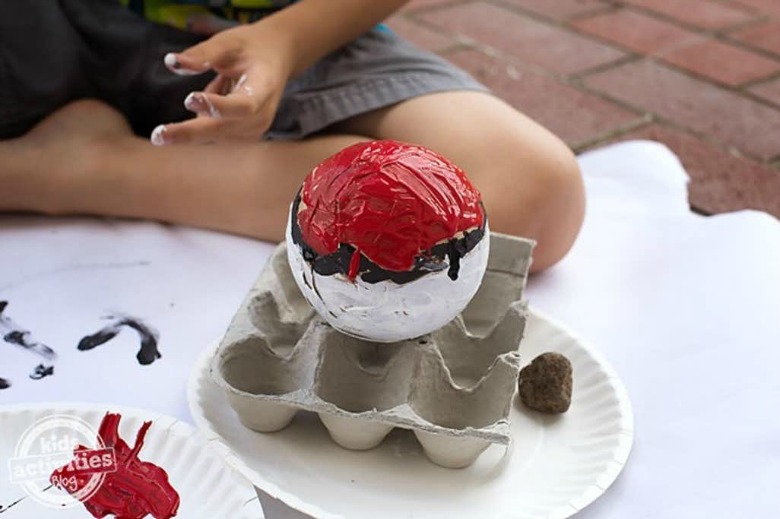 painting paper mache pokeballs - Pokemon crafts for kids