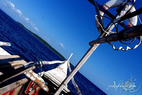 Island hopping, Philippine motorized banca sailing in blue sea