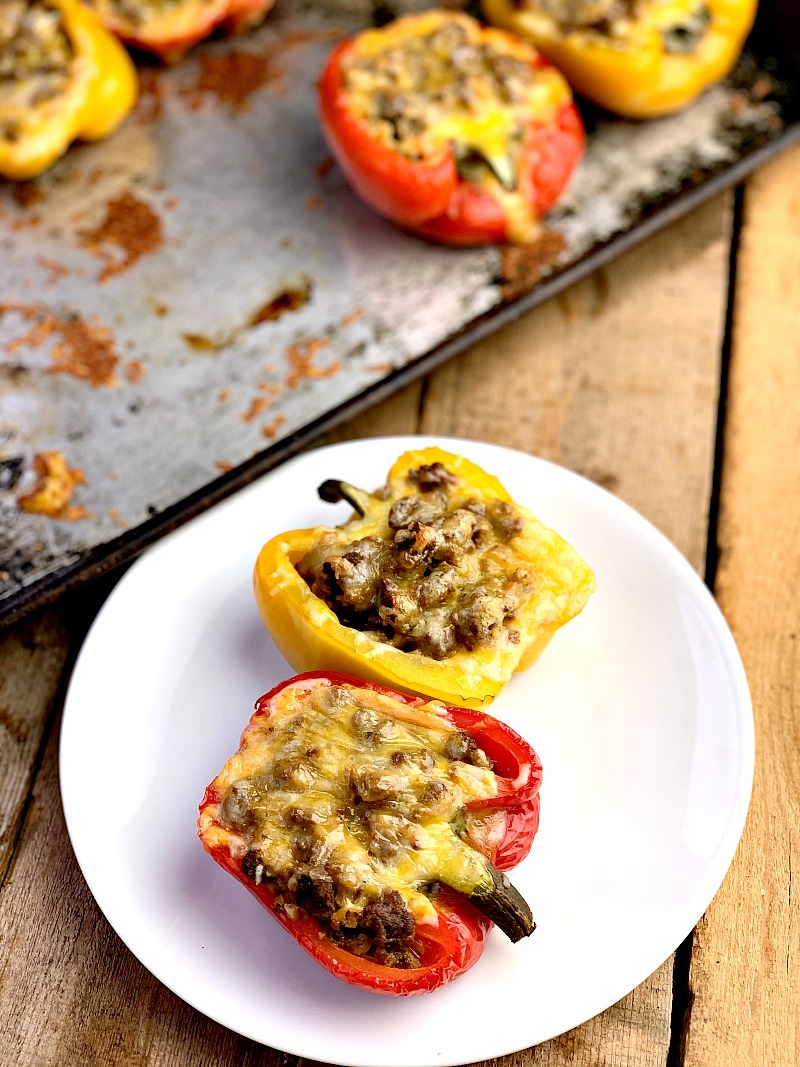 Low Carb Taco Stuffed Peppers - This Taco Stuffed Pepper recipe is a game-changer for a low carb lifestyle! Oven-roasted bell peppers packed with taco seasoned ground beef and topped with gooey melted cheese. This delicious alternative to tacos removes the tortillas and allows you to enjoy Taco Tuesday without all the added carbs or guilt. #lowcarb #keto #taco #peppers #stuffedpeppers #Mexican #recipe #5ingredients | bobbiskozykitchen.com