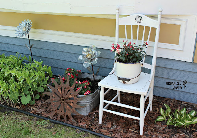 Junk Garden Chair Vignette #cultivatorwheel #gardenchair #galvanizedflower #shadegarden