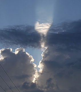 sun shining through gray clouds