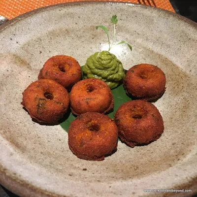 tiny ricotta and black bean vada--light as a beignet, and served with curry leaf chutney at Campton Place Restaurant in San Francisco, California