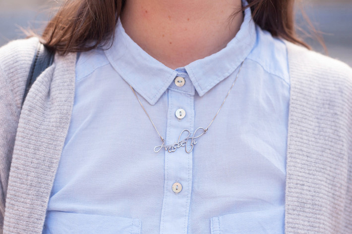 Name necklace over button up