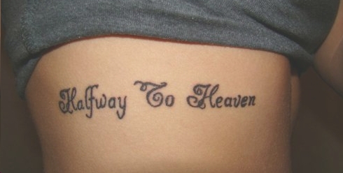 Made in heaven lettering tattoo on the rib.