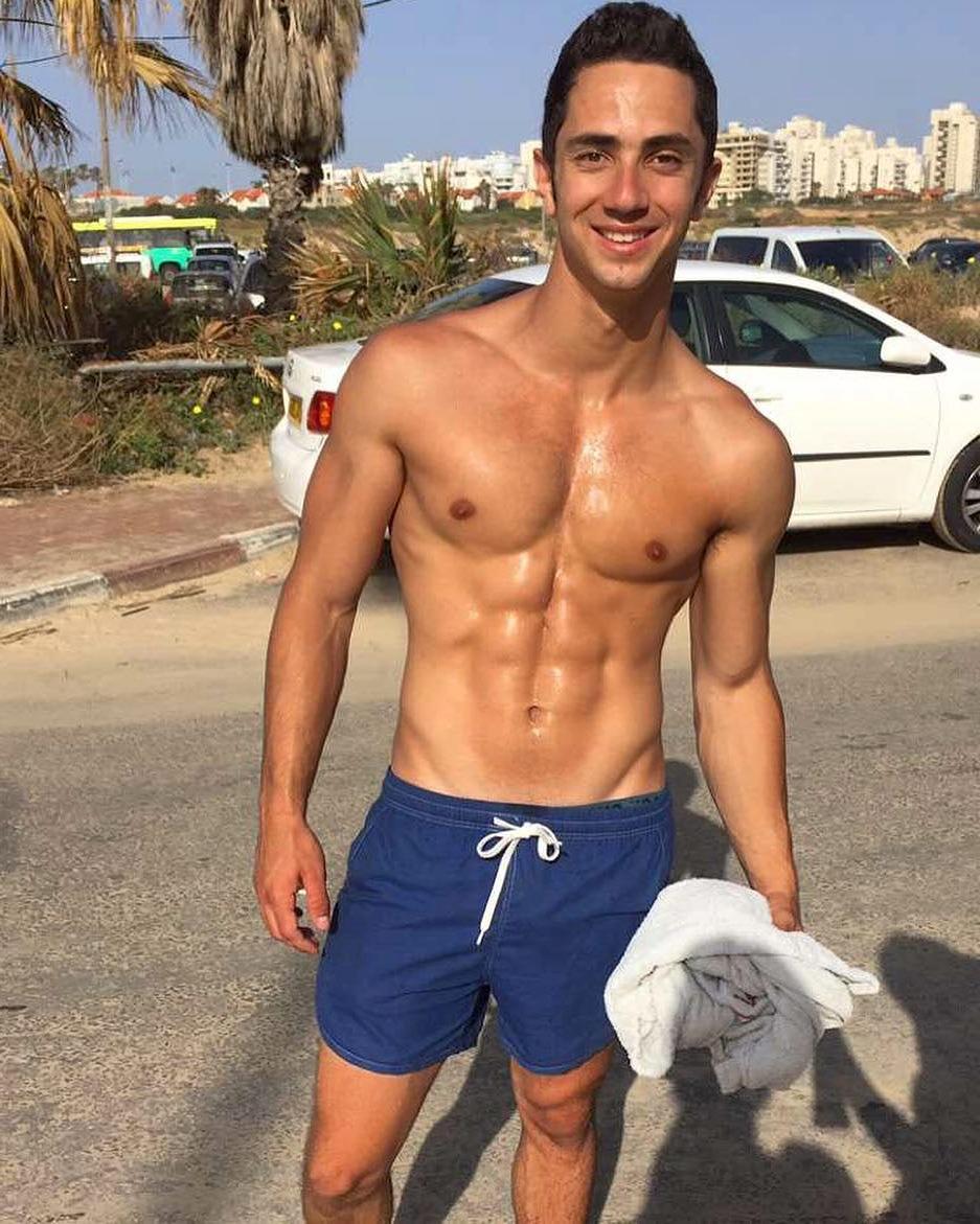 cute-young-guy-smiling-shirtless-shiny-abs