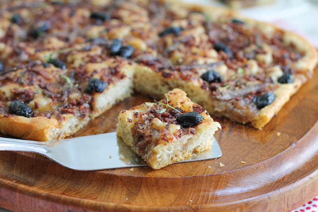 Food Lust People Love: This pissaladière or, to give it a much more descriptive name in English, Bacon Onion Anchovy Olive Tart is baked with a non-traditional sourdough crust. The bacon, anchovies and olives are beautifully salty, perfect atop the sweet onions. A square or two of pissaladière makes a great appetizer or anytime snack. If you don’t have time for all the rising and resting time necessary, feel free to substitute your favorite pizza dough instead.