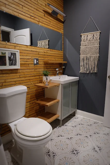 hall bathroom with lath wall, stencil paint floor, and Ikea hack cabinet