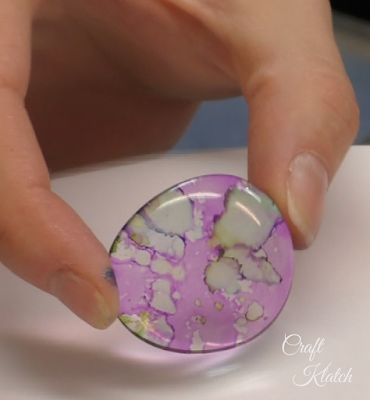 If you like to make jewelry and enjoy trying different mediums, alcohol ink on glass gives you a beautiful effect. You can create a pendant necklace that will be eye catching and great conversation starter! They are an easy craft, not to mention inexpensive and beautiful! DIY Alcohol Ink Pendants!!! alcohol ink, alcohol inks, pendants, jewelry, crafts, crafting, craft ideas, howto, handmade, craft, #howto #diy #diys #craft #crafts #crafting #howto #handmade #decor #repurpose Front of glass gem with purple and green alcohol ink