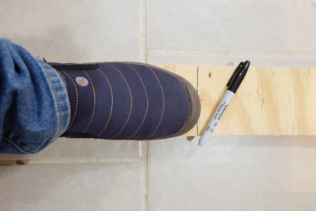 measure shoe on plywood