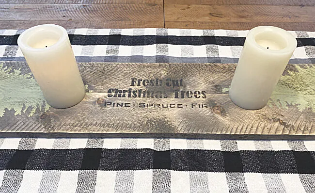Wooden table runner with christmas trees and candles