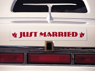 A car with a sign at the back written just marriage