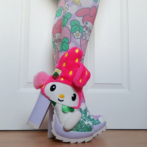 wearing ankle boots with large rubber platform and heel and fluffy Sanrio character on side