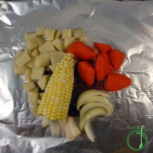 Morsels of Life - Burger and Veggies Foil Pack Step 5 - Place one quarter of the vegetables on top, sprinkle on garlic salt, and seal foil packs.