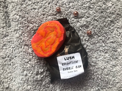 lush bright side bubble bar on a blanket