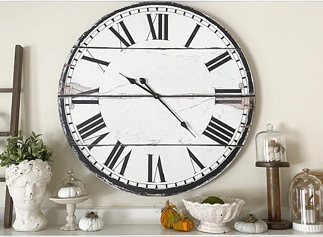 mantel with clock and pumpkins