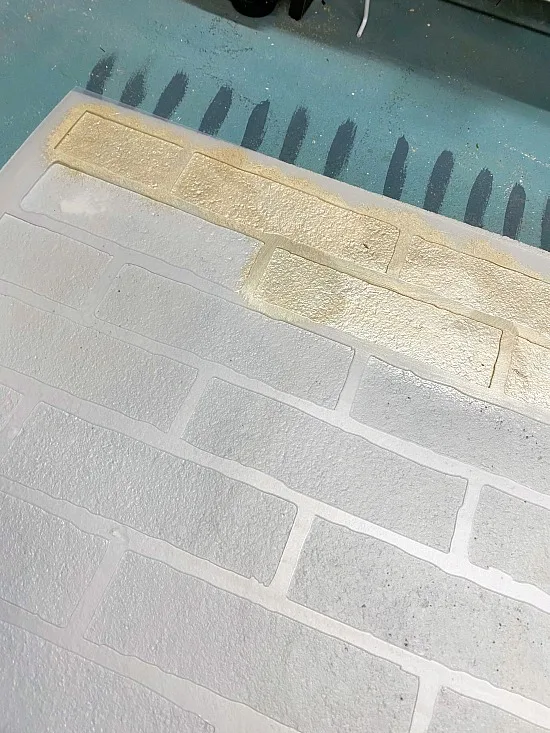 Large brick stencil with metallic gold stenciled brick