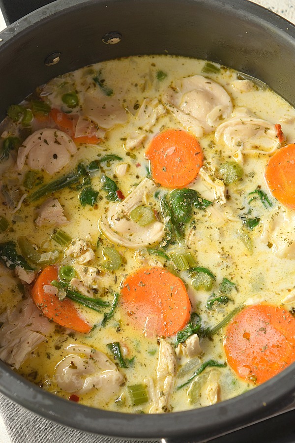 a pan with chicken and tortellini soup