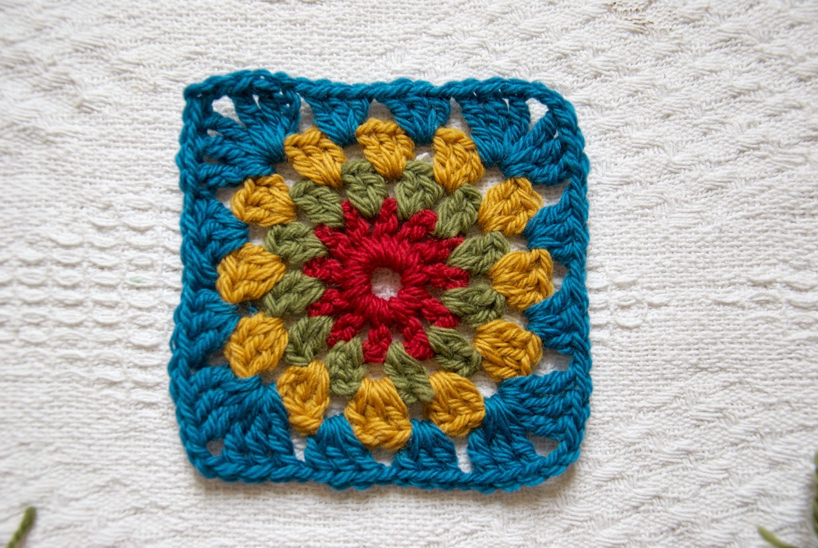 Crochet this classic granny square with a circle centre, using this free pattern.