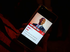 mobile phone displaying New York Post article on Kobe Bryant's death
