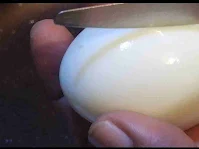 Piercing boiled egg for frying to make egg curry recipe